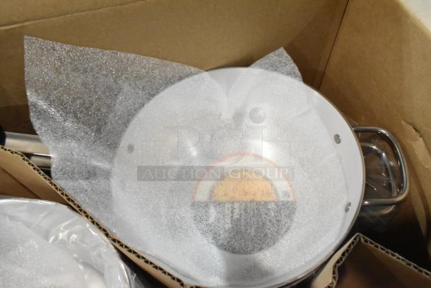 Box containing 6 brand new Wear-Ever 10376861 skillets and 6 Vollrath 382170 7-quart sauce pans with protective packaging.