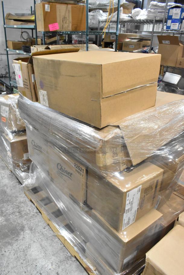 Pallet with cardboard boxes containing 24 brand new items including 1009VL, 10054596 teaspoons, Steelite teaspoons, Camwear 10312893 tumblers. Pallet wrapped in clear plastic for shipping, labels visible with item codes.