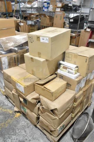 Boxes and packages on a pallet in a warehouse, labeled with brands and items including table knives, paper bags, bowls, and mugs.