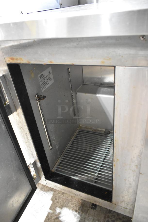 2018 Leader ESLB36SC stainless steel 2-door undercounter cooler, with commercial casters and visible interior wear.