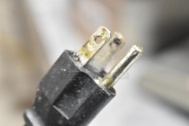 Close-up of a power plug for the MS-02 Metal Commercial Countertop Multi Function Fresh Meat Slicer, showing wear.
