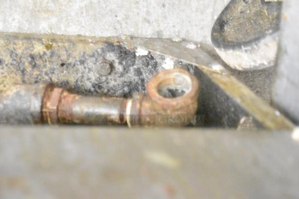 Close-up of corroded metal fittings on the Atosa ATFS-40 deep fat fryer, highlighting wear and tear.