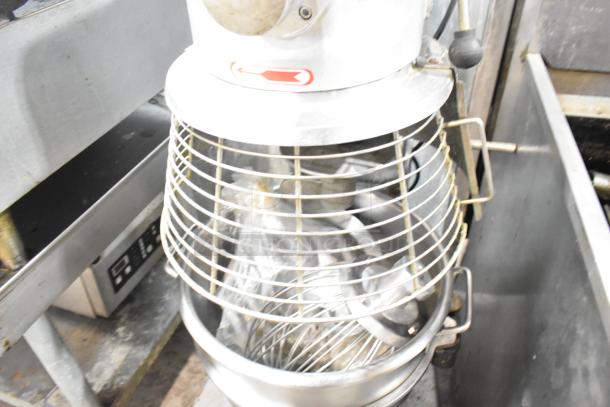 Skyfood commercial planetary dough mixer with mixing bowl, guard, dough hook, paddle, and whisk attachments.