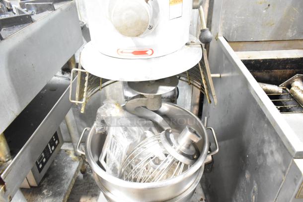 Skyfood commercial planetary dough mixer with bowl, guard, dough hook, paddle, and whisk attachments in used condition.