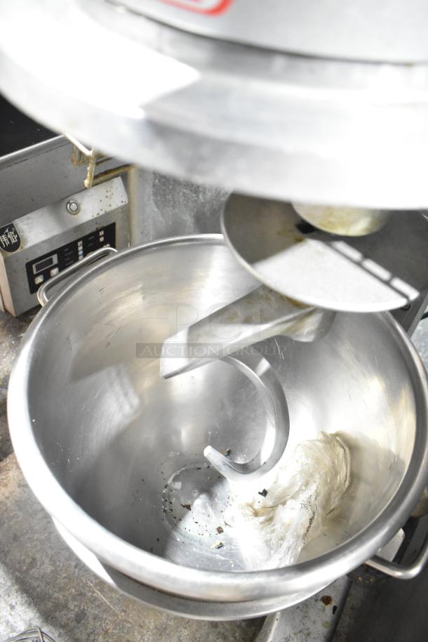 Skyfood metal commercial planetary dough mixer with bowl, guard, dough hook, paddle, and whisk attachments. Used condition.