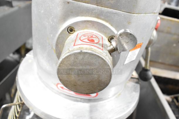 Skyfood metal commercial planetary dough mixer with floor style design, mixing bowl, bowl guard, dough hook, paddle, and whisk.