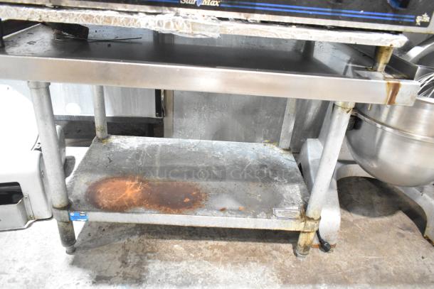 Star Max stainless steel 6-burner gas range on equipment stand, used, visible wear, sturdy design, commercial-grade.