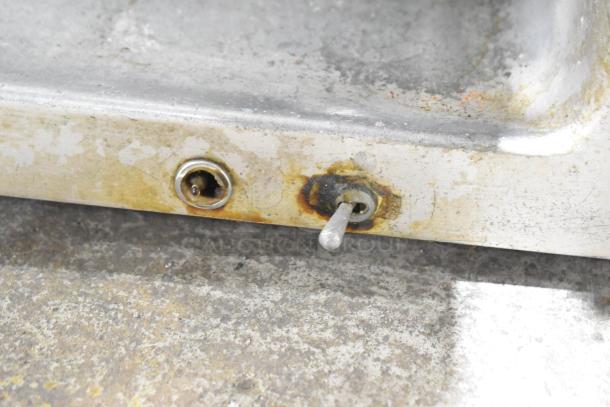 Metal commercial countertop meat slicer, 115 volts, 1 phase. Features signs of wear and rust on base, needs cleaning.