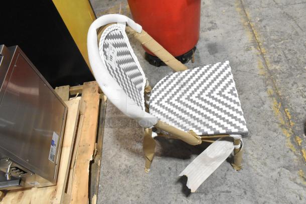 Brand new wicker style chair with a zigzag pattern in black and white. Protective wrapping visible, labeled "153 x 3".
