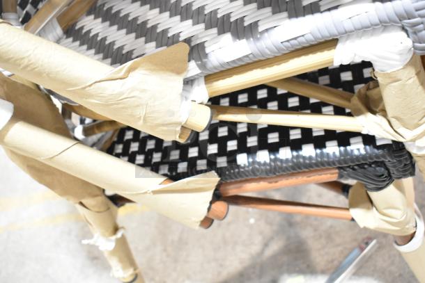 Three brand new wicker-style chairs with minor scratches and dents, wrapped in protective paper.