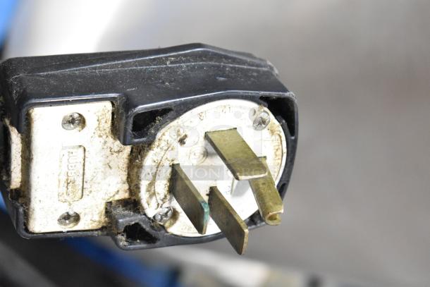 Close-up of a plug for a Turbochef HhC2020, showing the prongs and housing with visible wear.
