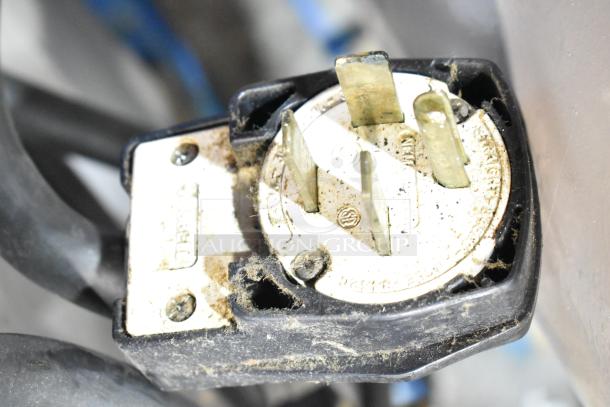 Close-up of a plug for a Turbochef HhC2020 rapid cook conveyor oven. The plug shows wear and dirt.