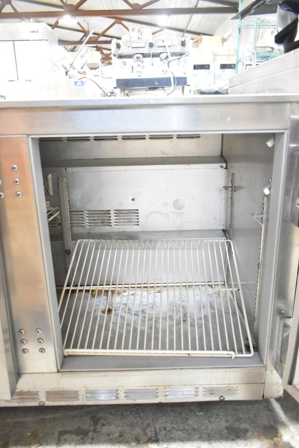 Beverage Air UCR48A stainless steel 2-door undercounter cooler, open view, on casters. Good condition. 115V, 1 phase.