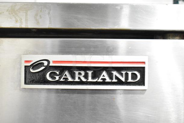 2 Garland Master 200 Stainless Steel Convection Ovens, solid doors, metal racks, thermostatic controls. Garland logo visible.
