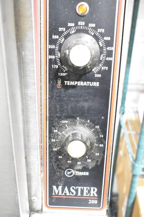 Garland Master 200 convection oven controls showing temperature and timer settings, black panel with white dials.