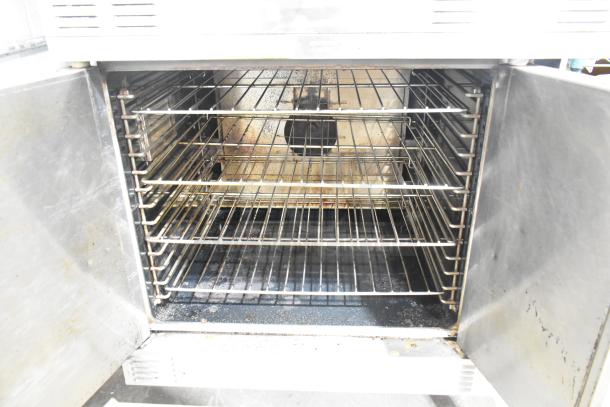 Garland Master 200 stainless steel convection oven with solid doors, featuring metal racks and thermostatic controls.