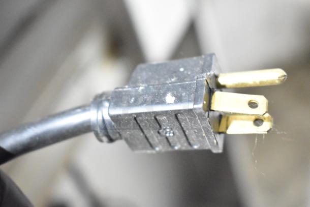 Close-up of a three-prong electrical plug, part of the Garland Master 200 Stainless Steel Commercial Convection Ovens.
