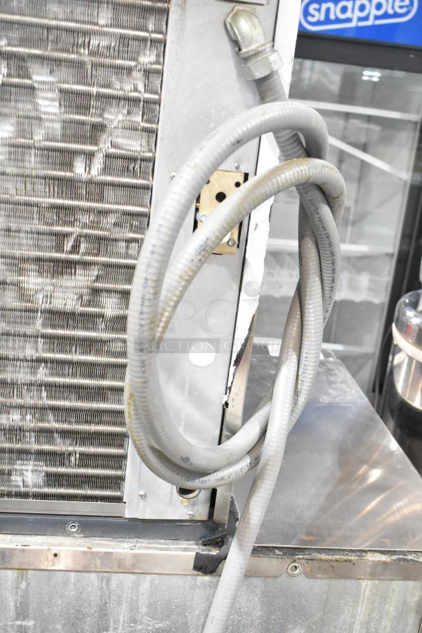 Stainless steel Scotsman C0830SA-32D ice machine head on BH800S-C bin. 208/230V, 1 Phase. Coiled hose visible.