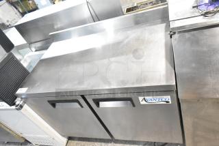 Avantco 178AWT48FHC stainless steel 2-door work top freezer on casters, with visible brand label, in good condition.