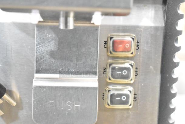 Omega OSD20 metal beverage machine controls close-up showing three labeled on/off switches.