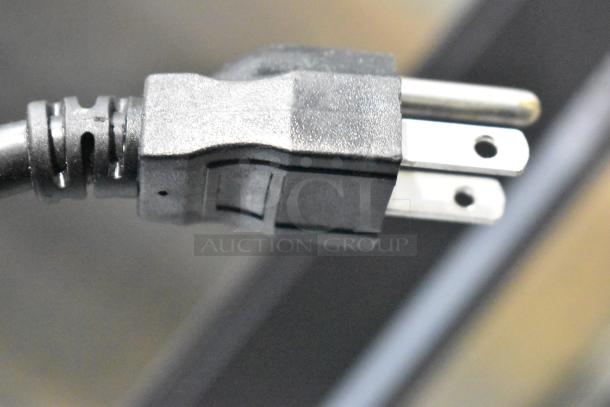 Close-up of a power plug, not showing the Omega OSD20 beverage machine.