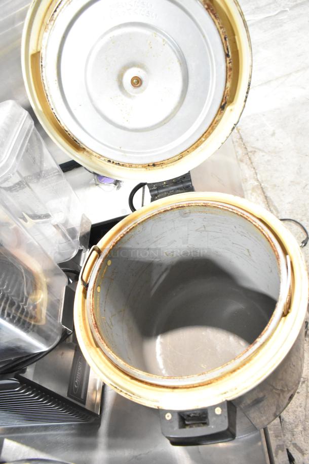 Two stainless steel countertop electric rice warmers, Thundergroup SEJ-22000 and Zojirushi THA-803S, 120V, showing interior condition.