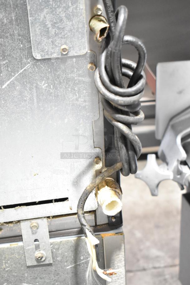 Ice-O-Matic ICE0400FW4 stainless steel ice machine with B40PSB bin. 115 volts, 1 phase. Visible wear on cables.