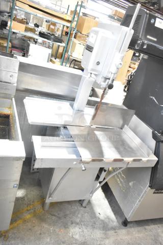 Hobart metal commercial floor-style meat saw in good condition, featuring a sturdy stainless steel base and visible Hobart logo.