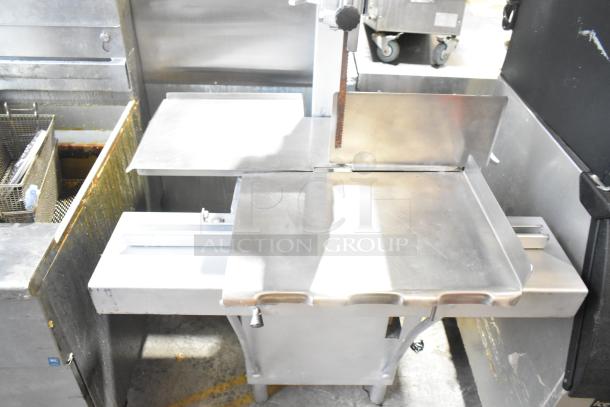 Hobart metal commercial floor-style meat saw, stainless steel, used condition, sturdy design, visible blade and cutting table.
