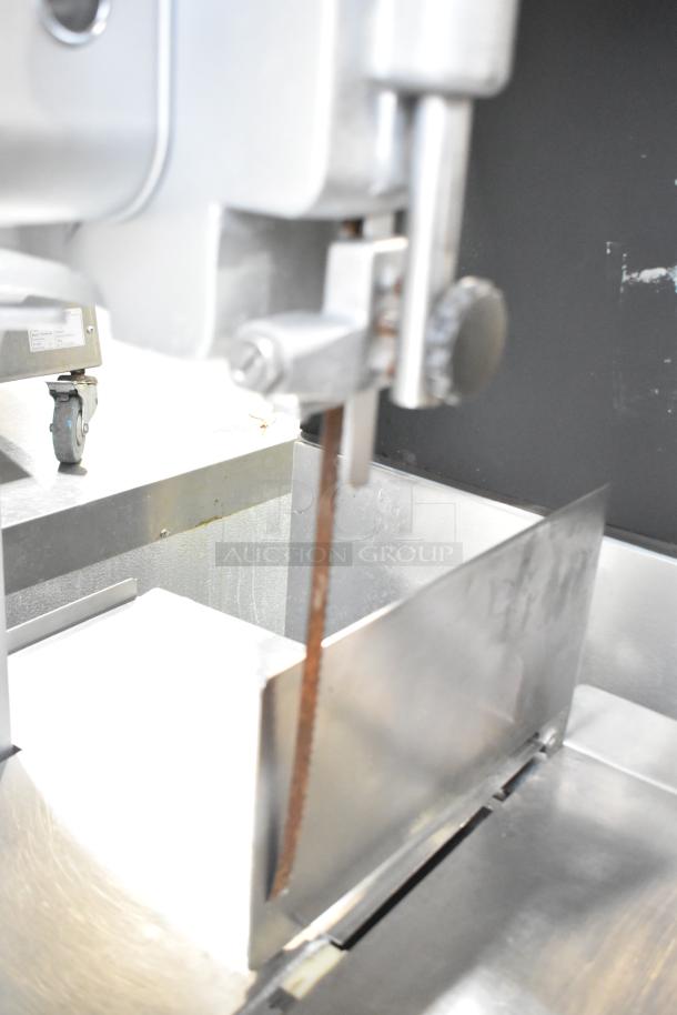 Hobart metal commercial floor style meat saw, showing a stainless steel blade and cutting surface, in used condition.