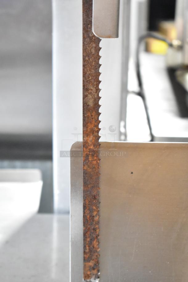 Hobart metal commercial floor-style meat saw with rust on the blade. Suitable for heavy-duty meat cutting.