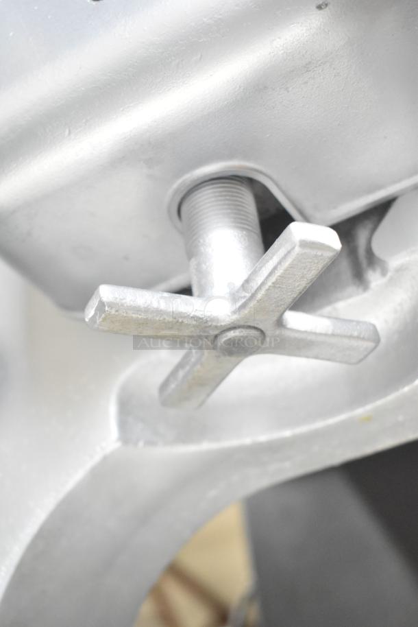 Hobart metal commercial floor meat saw, sturdy construction, featuring an adjustable tension knob, in good condition.