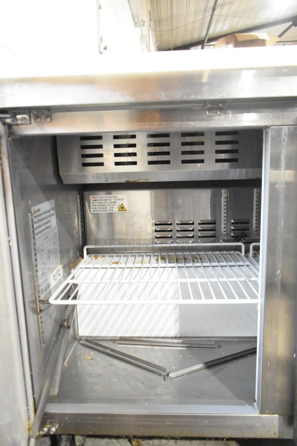 Avantco 178APT48HC stainless steel commercial sandwich salad prep table, visible interior shelf, minor wear, on casters.