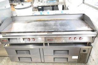 Lang stainless steel commercial countertop flat top griddle with thermostatic controls on 6-drawer chef base. Visible wear.