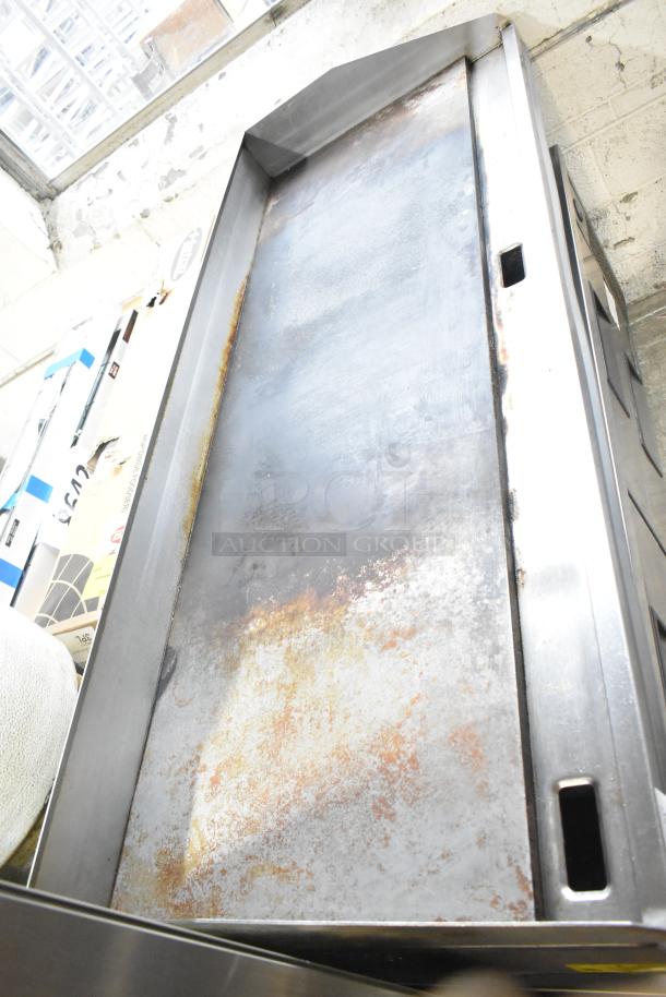 Lang stainless steel commercial countertop flat top griddle with thermostatic controls on 6-drawer chef base, used condition.