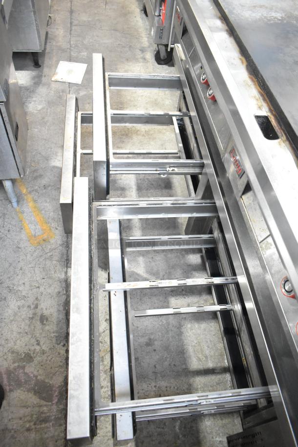 Lang stainless steel commercial countertop flat top griddle with thermostatic controls on a stainless steel six-drawer chef base.