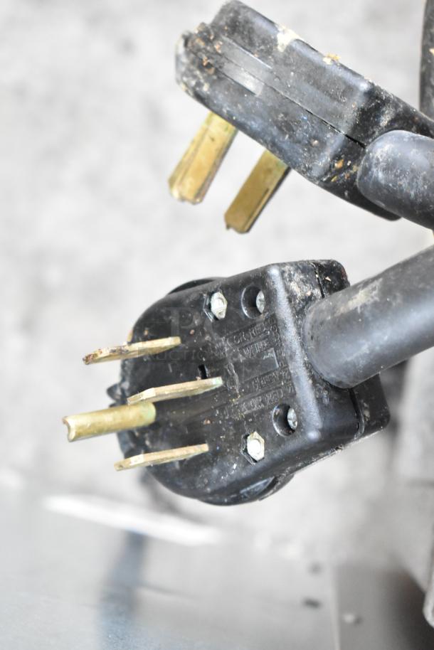 Lang Stainless Steel Commercial Flat Top Griddle power plug, showing four-prong configuration and wear marks.