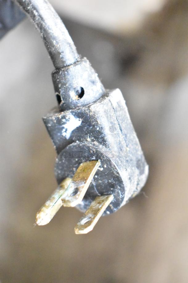 Close-up of a worn electrical plug.