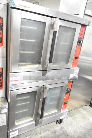 Vulcan VC4GD-11D350K stainless steel convection ovens, gas powered, view-through doors, metal racks, on casters.