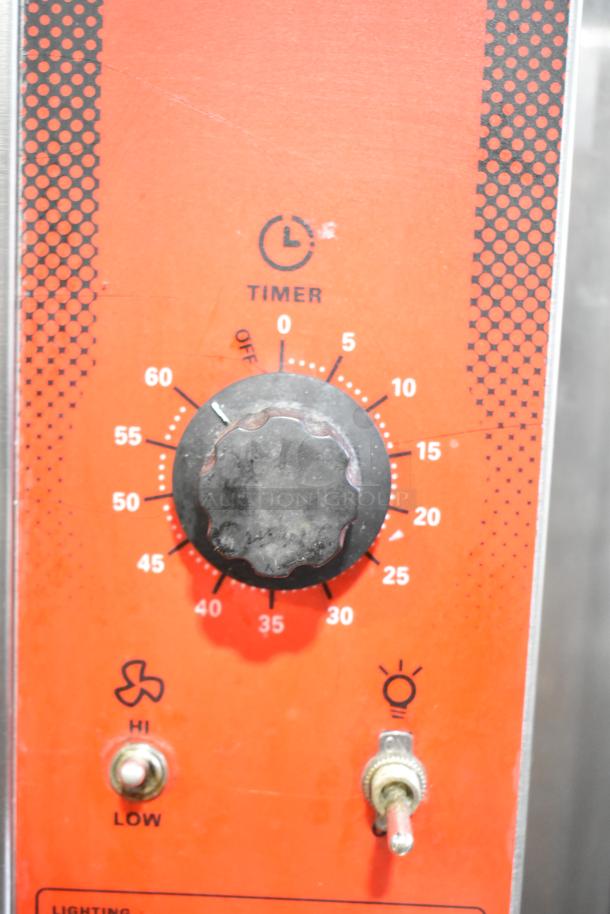 Timer control panel for Vulcan VC4GD-11D350K gas convection oven. Features a black knob with a 60-minute timer and toggle switches for fan settings and light.