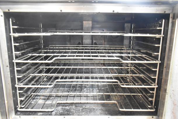 Vulcan VC4GD-11D350K stainless steel convection oven interior with metal racks, view-through doors, on commercial casters.