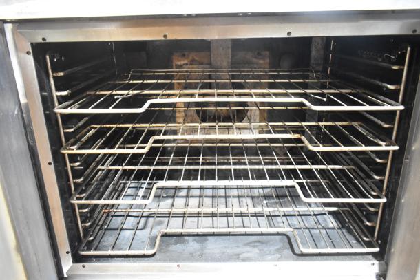 Vulcan VC4GD-11D350K stainless steel convection oven interior with metal oven racks, view-through doors, and thermostatic controls.