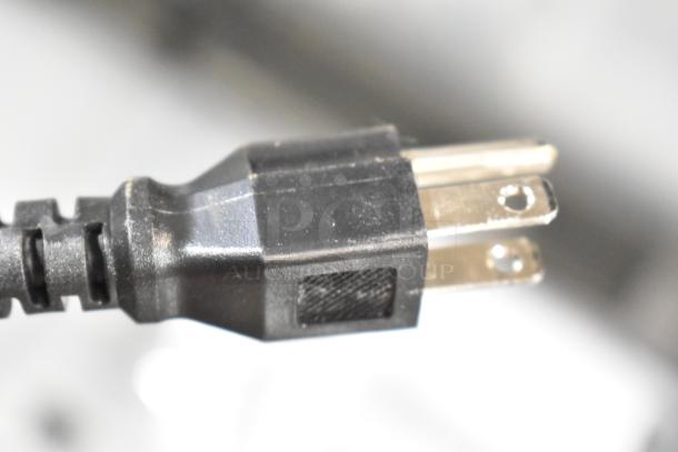 Close-up of a standard three-prong power plug for the Avantco 178MC58HC Commercial Milk Cooler, 115V, 1 Phase.