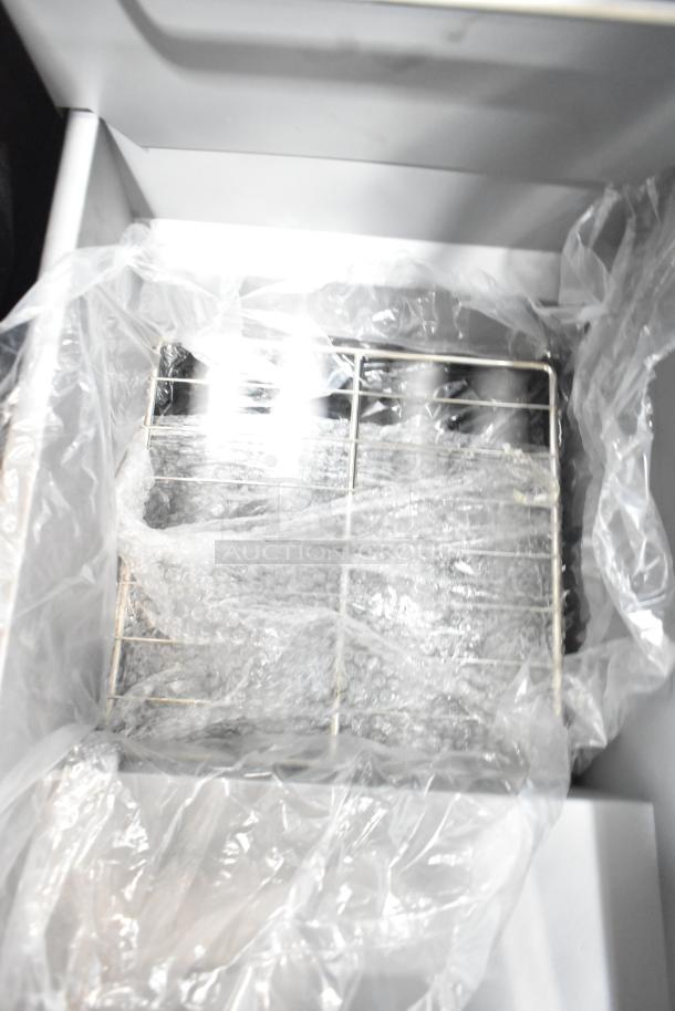 Brand new Avantco 177FF50N stainless steel deep fat fryer, 2024 model, 120,000 BTU, with 2 metal fry baskets.