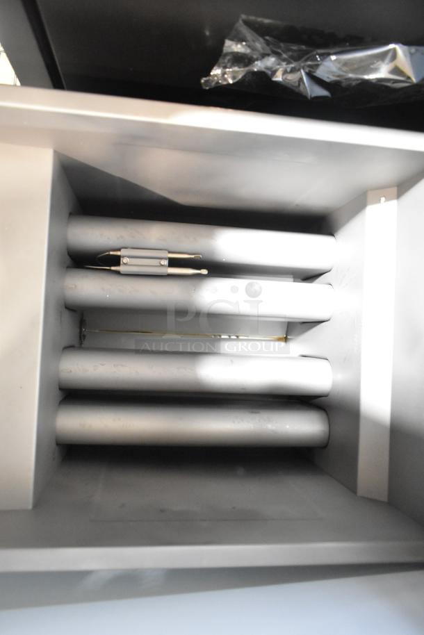 Brand new Avantco 177FF50N stainless steel commercial deep fryer interior view, showing heating elements. 120,000 BTU, gas-powered.