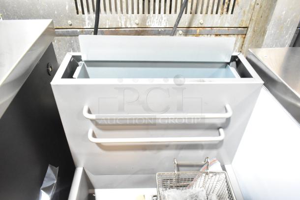 Brand new Avantco 177FF50N stainless steel deep fat fryer, 120,000 BTU, with 2 metal fry baskets, natural gas powered.