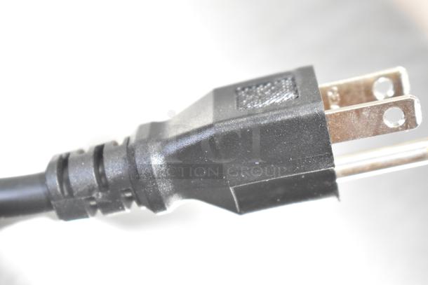 Close-up of a black, three-pronged power plug from an Avantco 178UDD48HC kegerator beer dispenser.