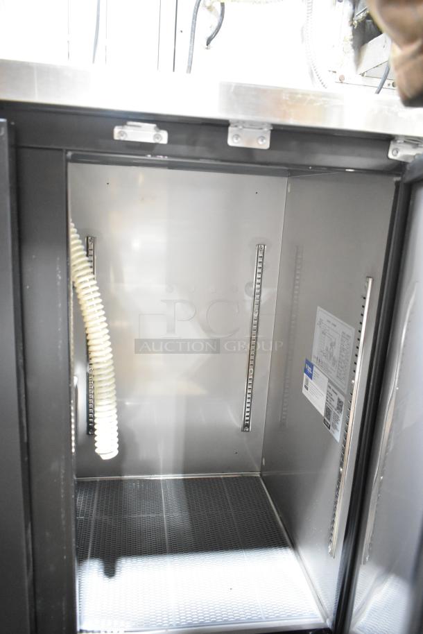 Brand new Avantco 178UDD48HC kegerator interior, showing clean metal finish and shelving slots. Dual tap, half keg capacity.