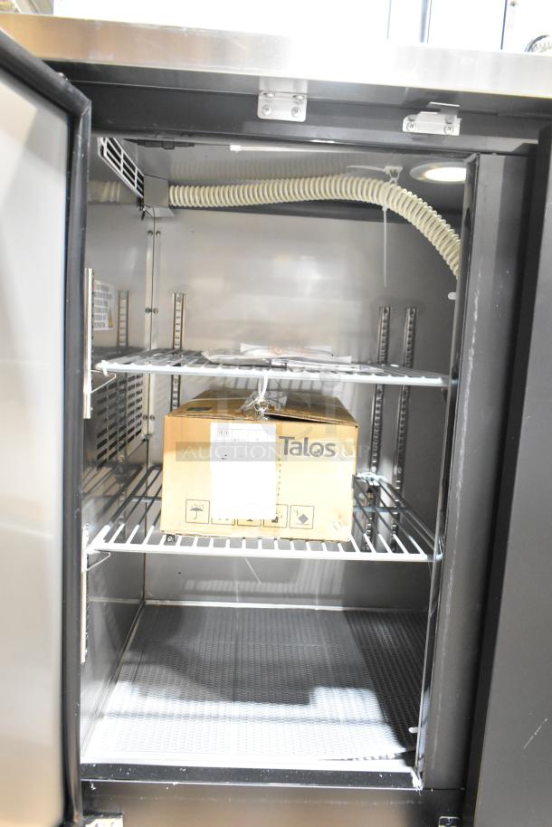 Avantco 178UDD48HC double tap kegerator, black, new, holds (2) 1/2 kegs, 115V, interior view showing shelves and packaging.