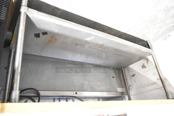 Wooden butcher block table with metal under shelf, featuring sturdy metal frame and visible wear. Ideal for kitchen prep.